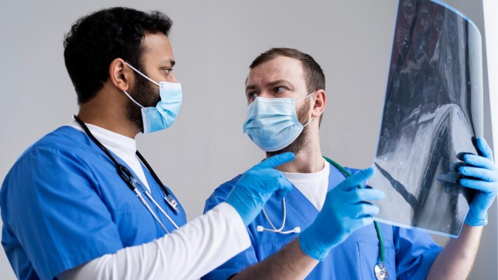 When to See a Brachial Plexus Surgeon consultation showing medical specialists reviewing imaging scans to assess nerve injury and treatment planning.